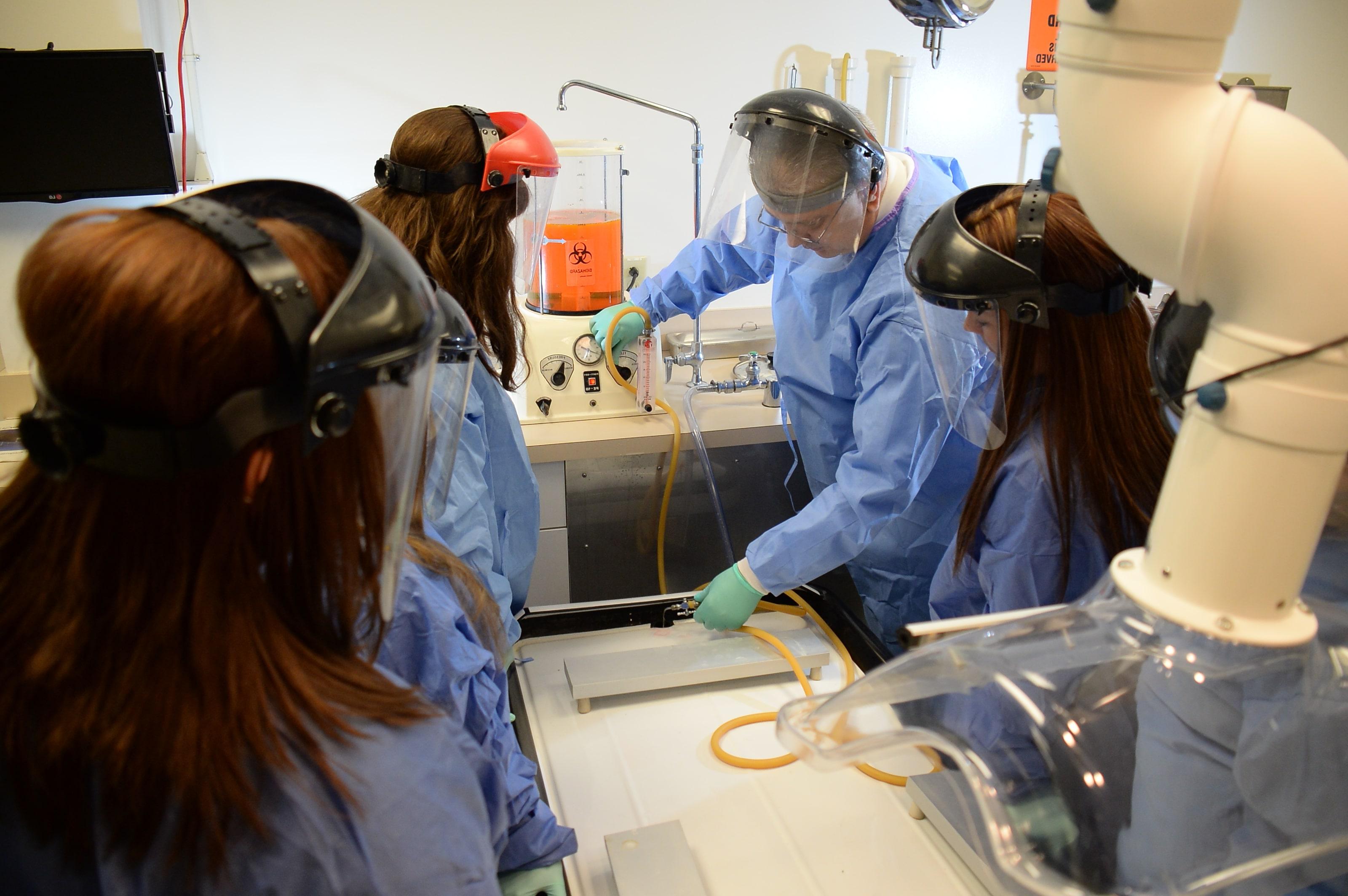 A surgery professor teaching his students